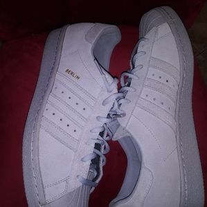 A pair of Adidas shell toe